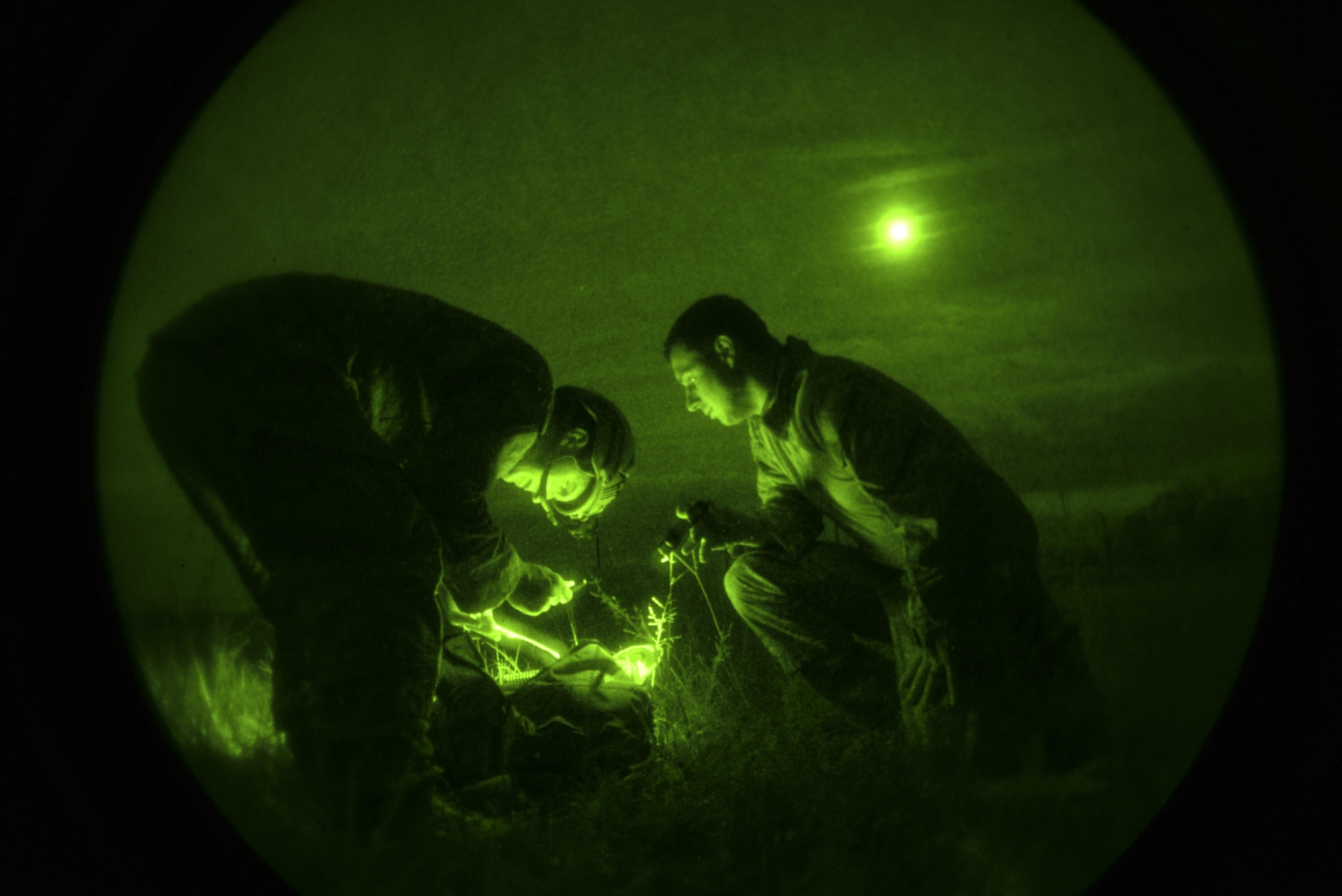 Senior Airman Frank Kritzman (left) and Staff Sgt. Adam Wickizer, both explosive ordnance disposal technicians with the 633rd Civil Engineer Squadron at Joint Base Langley-Eustis, Va., work together to identify a potential threat as part of Operation Llama Fury, Aug. 27, 2015, at Seymour Johnson Air Force Base, N.C. To further test their abilities, each team was able to “purchase” a select amount of gear in order to conduct different scenarios under the guise of darkness. (U.S. Air Force photo/Senior Airman Brittain Crolley)