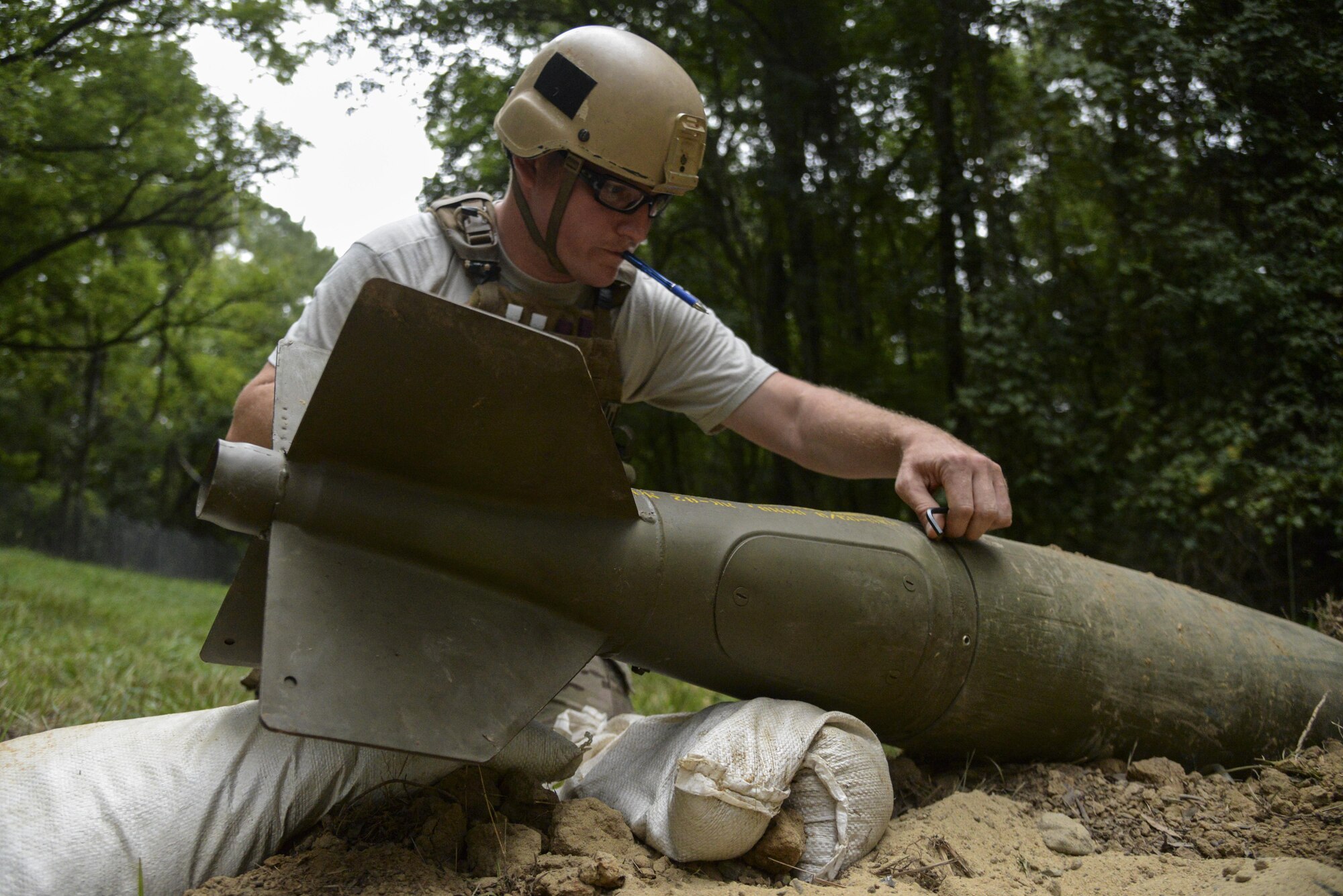 Staff Sgt. Alex Blair, an explosive ordnance disposal technician with the 11th Civil Engineer Squadron at Joint Base Andrews, Md., responds to an unexploded ordnance threat as part of Operation Llama Fury, Aug. 26, 2015, at Seymour Johnson Air Force Base, N.C. During the scenario, Blair and his team removed a nose and tail fuse from the UXO as well as the firing pin in order to render the munition safe. (U.S. Air Force photo/Senior Airman Brittain Crolley)