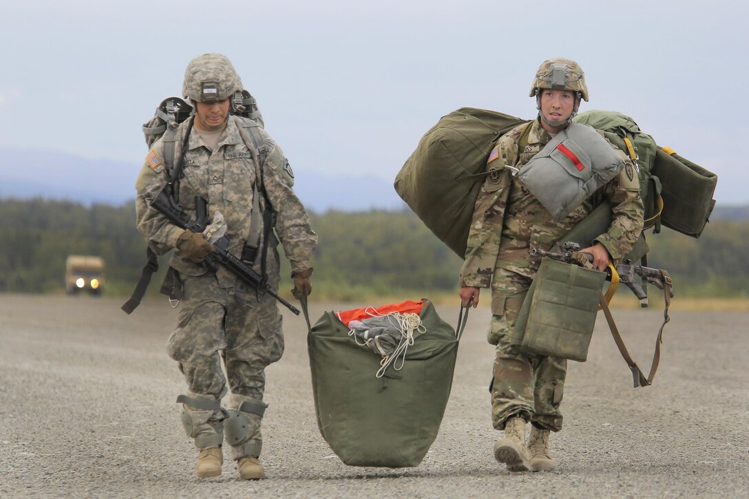 Paratroopers proceed to the rally point after conducting a practice jump during Pacific Airlift Rally 2015 on Malemute drop zone, Joint Base Elmendorf-Richardson, Alaska, Aug. 27, 2015. The paratroopers are assigned to the 25th Infantry Division's Company H, 3rd Battalion, 509th Infantry Regiment, 4th Infantry Brigade Combat Team Airborne, Alaska. The Alaska Air National Guard's 176th Wing co-hosted the exercise. U.S. Air Force photo by Alejandro Pena