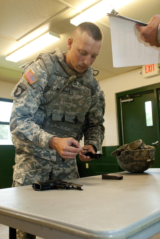 FORT McCOY, Wis. Sgt. 1st Class Jason J. Manella, a native of Fremont, Calif., Civil Affairs Specialist assigned to Bravo Co. 445th U.S. Army Civil Affairs Battalion, 351st Civil Affairs Command assembles his assigned 9mm pistol while preforming the assembly, disassembly and functions check of a 9mm during the 2013 Army Reserve Best Warrior Competition, June 24. (U.S. Army Reserve photo by Cpl. Jeff Shackelford, 343rd Mobile Public Affairs Detachment)  