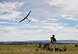 Staff Sgt. Leland Hastings, 919th Special Operations Security Forces Squadron, launches Raven-B, a four-by-four foot unmanned aerial system, into the skies above Camp Guernsey, Wyo., Aug. 4.  The 919th SOSFS brought the UAS to demonstrate its capabilities to other security forces units involved in a large field training exercise at the camp. The Raven-B has the ability to take photos, video in day or night, and even designate locations via an IR laser.  It also provides coordinates, magnetic azimuths, and linear distances creating a birds-eye view to topographical map. (U.S. Air Force photo/Tech. Sgt. Sam King)