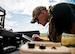 Staff Sgt. Leland Hastings, 919th Special Operations Security Forces Squadron, monitors the Raven-B, a four-by-four foot unmanned aerial system, through a laptop computer at Camp Guernsey, Wyo., Aug. 4.  The 919th SOSFS brought the UAS to demonstrate its capabilities to other security forces units involved in a large field training exercise at the camp. The Raven-B has the ability to take photos, video in day or night, and even designate locations via an IR laser.  It also provides coordinates, magnetic azimuths, and linear distances creating a birds-eye view to topographical map. (U.S. Air Force photo/Tech. Sgt. Sam King)