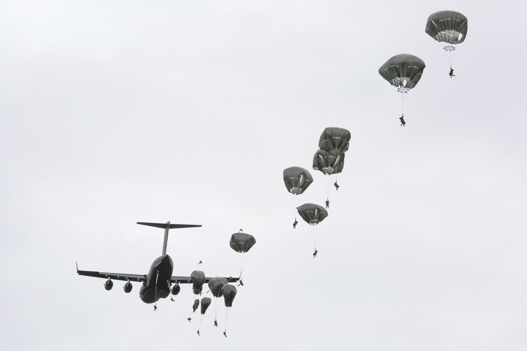 Paratroopers jump from a C-17 Globemaster III aircraft during a practice personnel drop as part of Pacific Airlift Rally 2015 over Malemute drop zone on Joint Base Elmendorf-Richardson, Alaska, Aug. 27, 2015. U.S. Air Force photo by Alejandro Pena