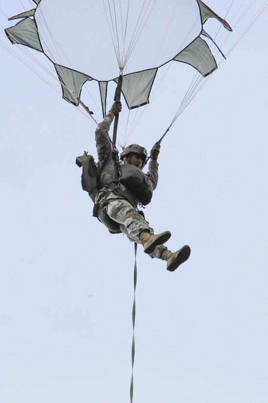 A paratrooper descends after jumping from a C-17 Globemaster III 
aircraft during a practice personnel drop as part of Pacific Airlift Rally 2015 over Malemute drop zone on Joint Base Elmendorf-Richardson, Alaska, Aug. 27, 2015. U.S. Air Force photo by Alejandro Pena