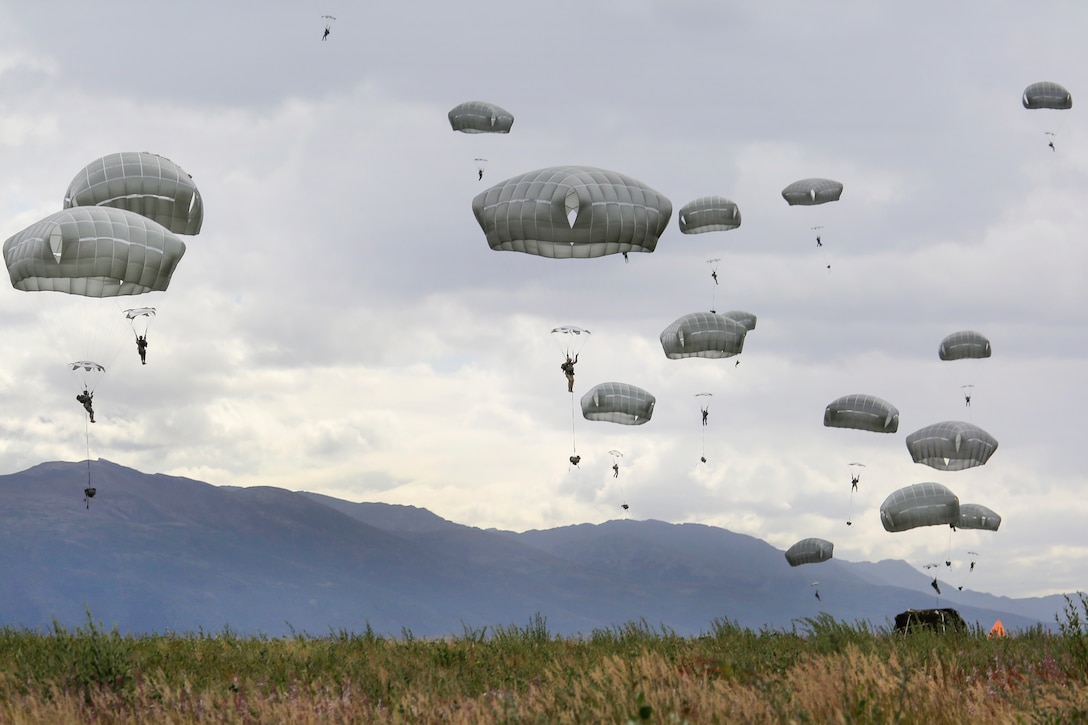 Paratroopers descend after jumping from a C-17 Globemaster III aircraft during a practice drop as part of Pacific Airlift Rally 2015 over Malemute drop zone on Joint Base Elmendorf-Richardson, Alaska, Aug. 27, 2015. U.S. Air Force photo by Alejandro Pena