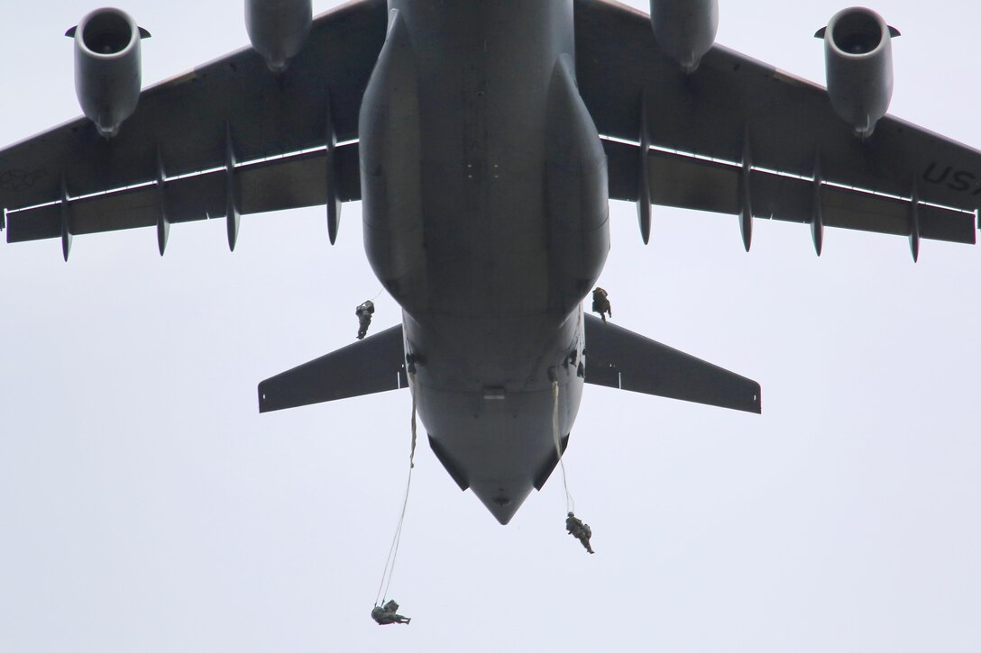 Paratroopers jump  from a C-17 Globemaster III aircraft during a practice personnel drop as part of Pacific Airlift Rally 2015 over Malemute drop zone on Joint Base Elmendorf-Richardson, Alaska, Aug. 27, 2015. The tactical military exercise  enhances military airlift interoperability and cooperation between nations of the Pacific region for future humanitarian missions.U.S. Air Force photo by Alejandro Pena