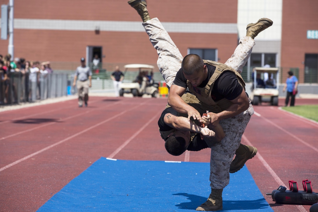 U.S. Marine Corps Sgts. Christopher Flores, right, and Robert Parente demonstrate takedowns at Sunny Slope High School during Marine Week 2015 in Phoenix, Sept. 8, 2015. Marine Week Phoenix provides an opportunity to showcase the Marines and help people understand the capabilities of the Marine Corps. U.S. Marine Corps photo by Cpl. Trever A. Statz