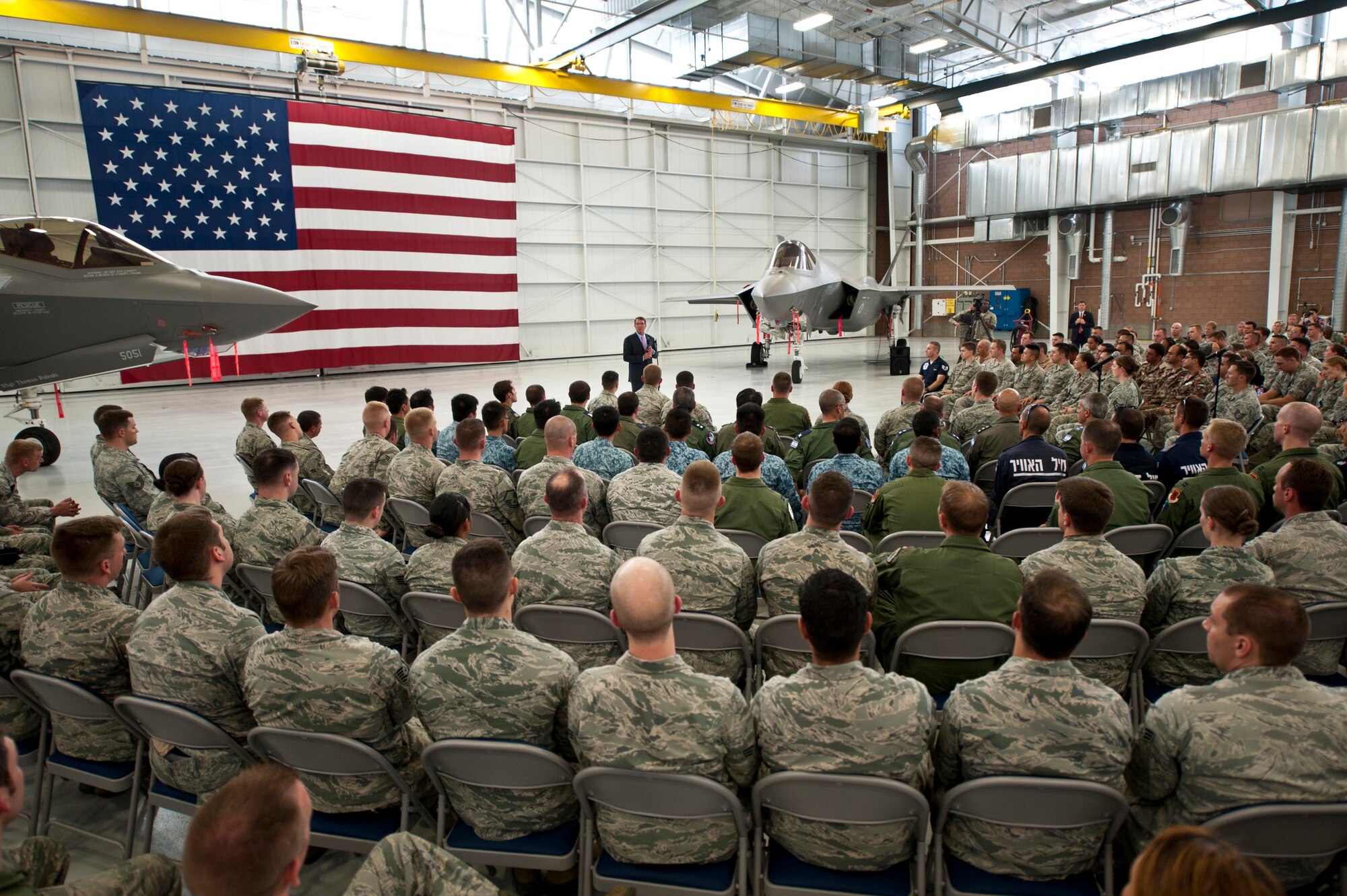 Defense Secretary Ash Carter addresses Airmen and coalition partners during an all call at Nellis Air Force Base, Nev., Aug. 26, 2015. During the secretary’s visit to Nellis he observed Red Flag 15-4 and spoke to Airmen and Coalition partners. During the all call, Carter took questions from service members and addressed issues relating to budgets, force retention, morale, and operational priorities. (U.S. Air Force photo/Senior Airman Joshua Kleinholz)