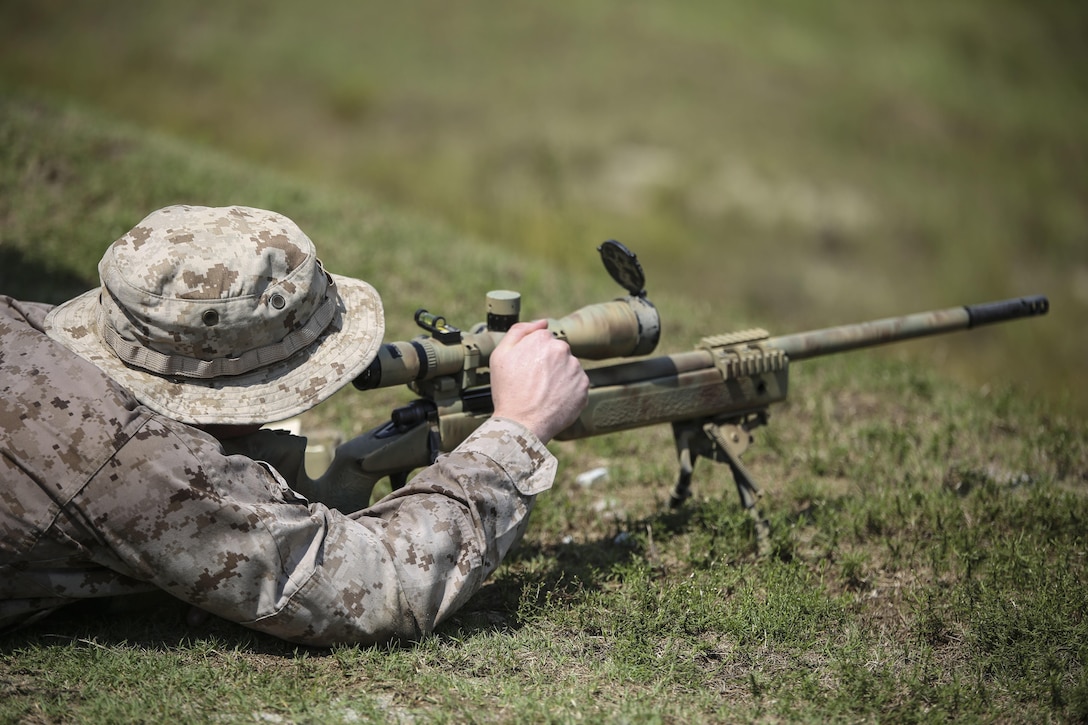 A Marine with Sniper Platoon, Weapons Company, 2nd Battalion, 6th Marine Regiment, adjusts the scope of an M40 bolt-action sniper rifle during a weapons zeroing range at G21, Camp Lejeune, N.C., Sept. 3, 2015. The M40 sniper rifle is capable of hitting a target at 1,000 yards. (U.S. Marine Corps photo by Cpl. Paul S. Martinez)