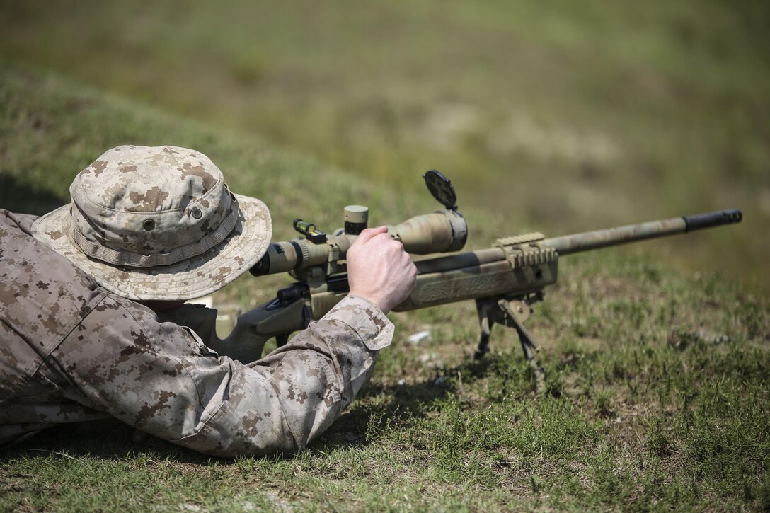 A Marine with Sniper Platoon, Weapons Company, 2nd Battalion, 6th Marine Regiment, adjusts the scope of an M40 bolt-action sniper rifle during a weapons zeroing range at G21, Camp Lejeune, N.C., Sept. 3, 2015. The M40 sniper rifle is capable of hitting a target at 1,000 yards. (U.S. Marine Corps photo by Cpl. Paul S. Martinez)