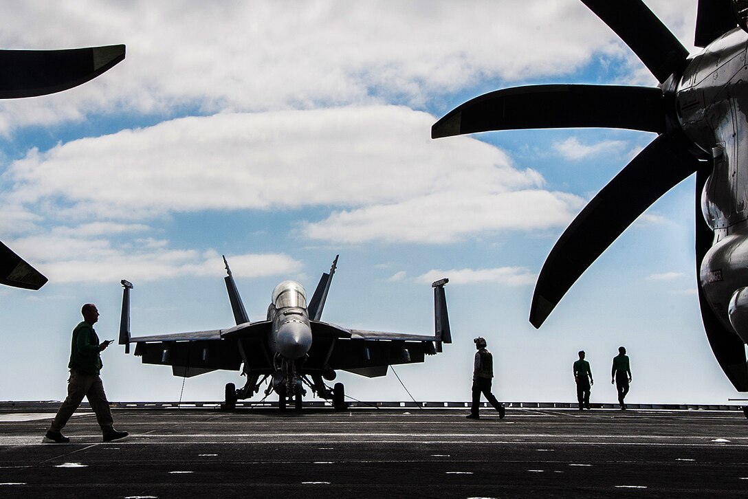 U.S. sailors transit the flight deck of the aircraft carrier USS Ronald Reagan in the Pacific Ocean, Sept. 5, 2015. The carrier and its embarked air wing, Carrier Air Wing  5, provide a combat-ready force that protects the collective maritime interests of its allies and partners in the Indo-Asia-Pacific Region. U.S. Navy photo by Petty Officer 3rd Class Nathan Burke