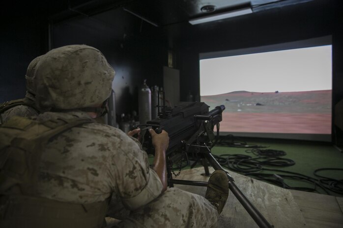 A Marine with Weapons Company, 2nd Battalion, 2nd Marine Regiment, fires on virtual targets with an Mk-19 automatic grenade launcher during training at the Indoor Simulated Marksmanship Trainer aboard Camp Lejeune, N.C., Aug. 5, 2015. The ISMT—used to train Marines on Mk 19s, M2 50-caliber machine guns, M240 medium machine guns and M16 service rifles—will be part of the Marine Corps Systems Command display at Marine Week Phoenix Sept. 10-13.