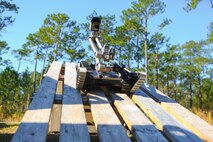 An R2C Robot, operated by a Marine with 2nd Combat Engineer Battalion, 2nd Marine Division, drives down an obstacle during a training exercise aboard Marine Corps Base Camp Lejeune, N.C., March 11, 2014. Marine Corps Systems Command will demonstrate capabilities of several robots Marines use in the field during Marine Week Phoenix Sept. 10-13.