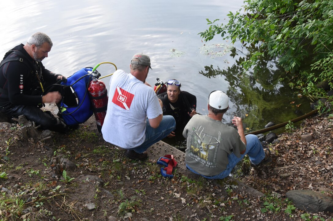 St. Paul District divers inspected five of the district’s six Mississippi River Headwaters reservoir dams the week of August 31, 2015.  Here, St. Paul District certified divers Josh Rye, left, and Eric Lockington, prepare to inspect the upstream side of the Sandy Lake Dam, near McGregor, Minn. Assisting them are Kraig Berberich and Randy Piel. 
