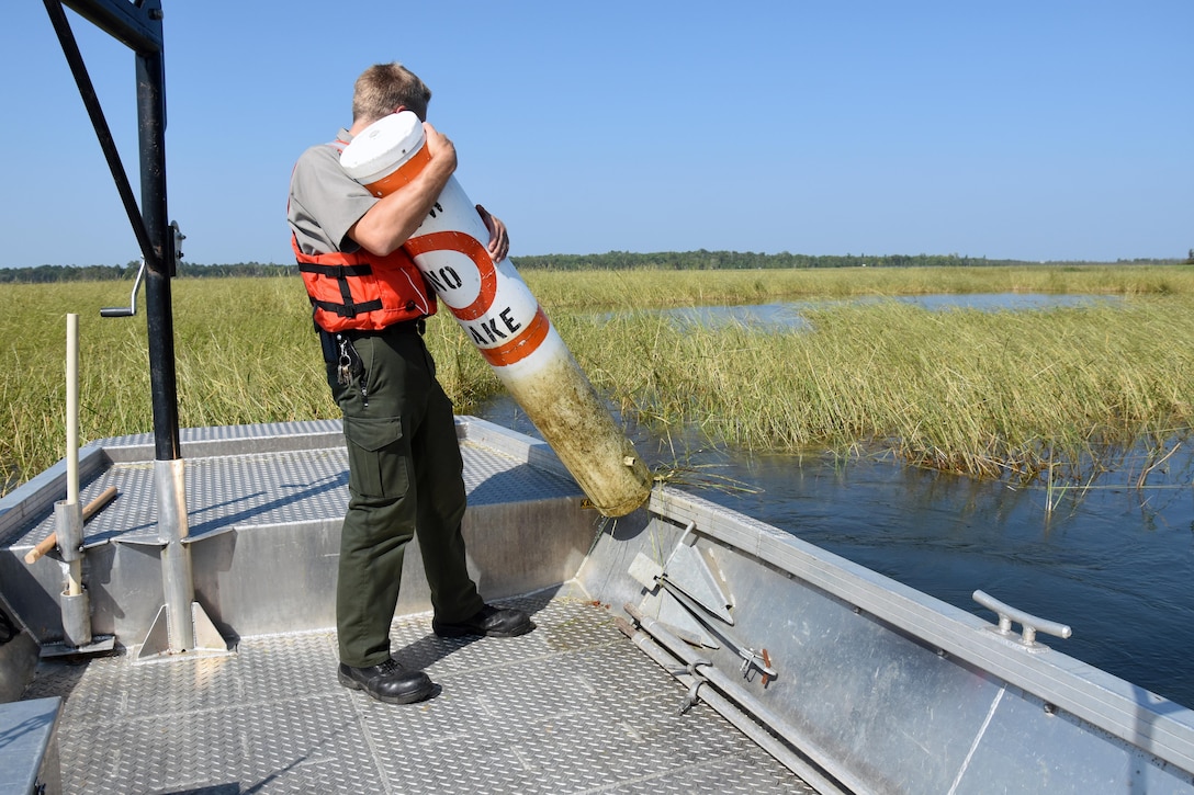 Gus Garbe, park ranger at Leech Lake, Federal Dam, Minn., adjusts a buoy that designates a no wake zone near the boat ramp Sept. 3, 2015. The buoys, which are anchored with a block of concrete, need to be adjusted periodically throughout the recreation season. All buoys are removed prior to the lake freezing and cleaned or repaired during the off-season.