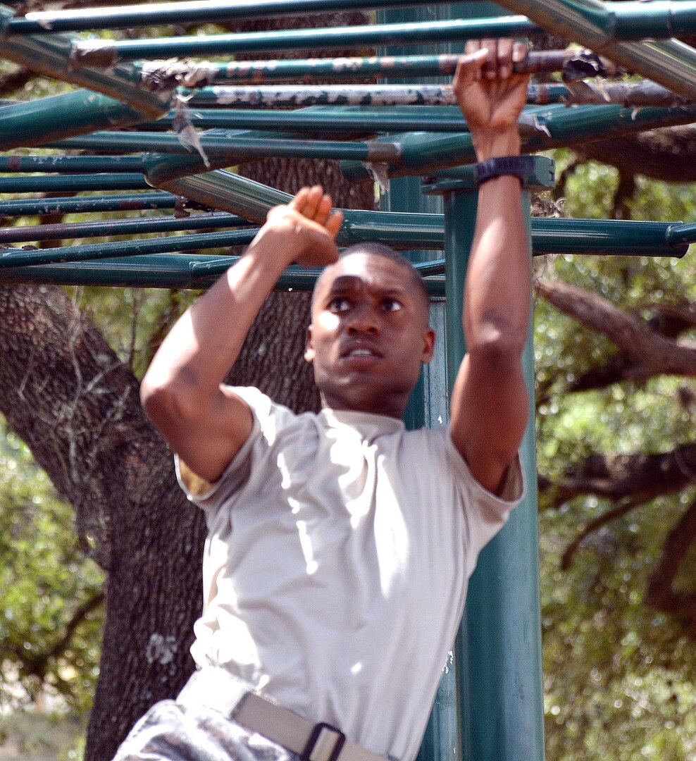 Sgt. 1st Class Antwan Williams tackles the “Tarzan bars” at the obstacle course during the 2015 U.S. Army Medical Department Center and School, U.S. Army Health Readiness Center of  Excellence Best Medic competition at Camp Bullis Sept. 2.  Williams is with the Academy Brigade and was the overall top individual scorer.