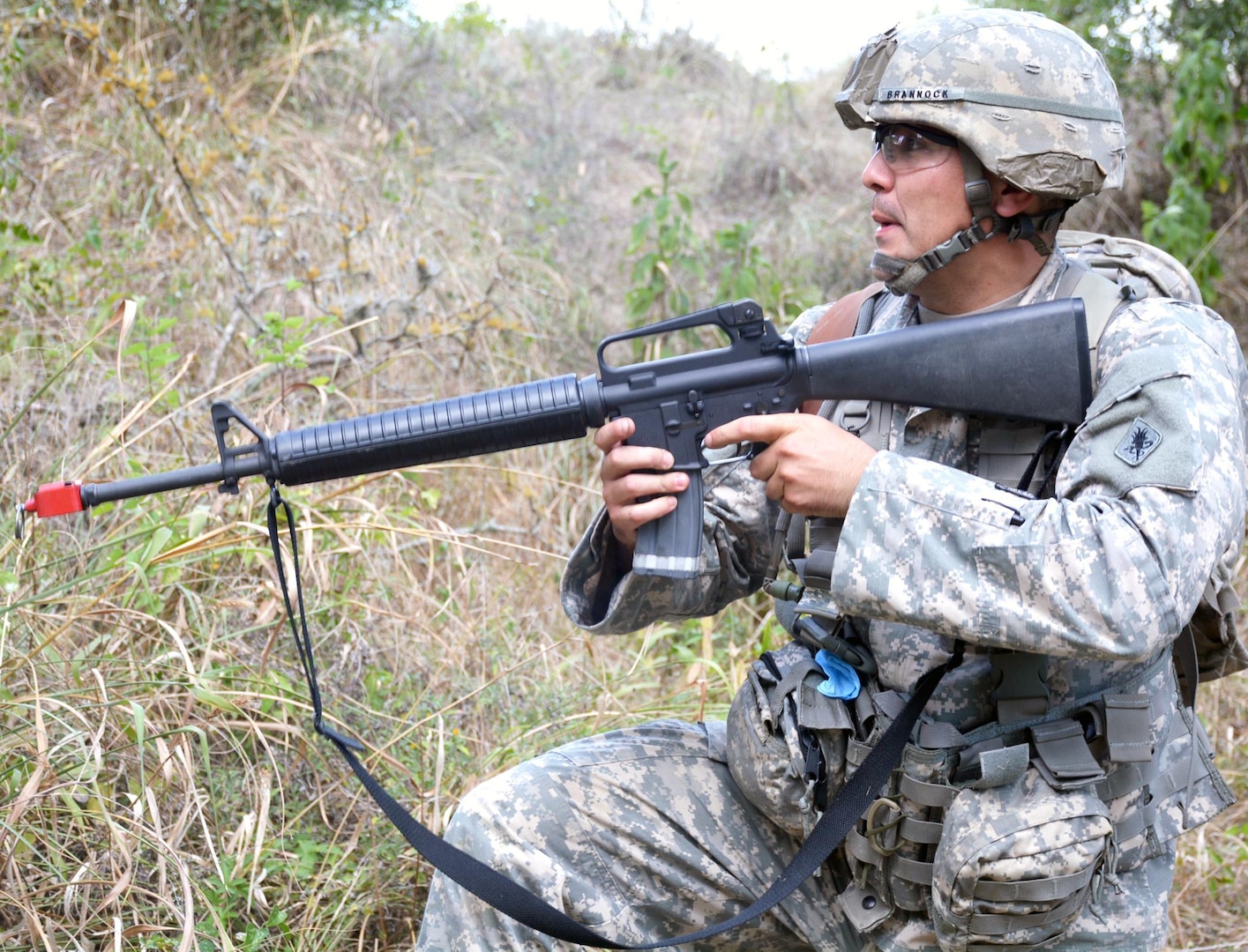First Sgt. Robert Brannock, Academy Brigade, U.S. Army Medical Department Center and School, U.S. Army Health Readiness Center of Excellence, reacts to enemy gun fire at the warrior task and battle drills lanes during the 2015 AMEDDC&S, HRCoE Best Medic competition at Camp Bullis Sept. 2.