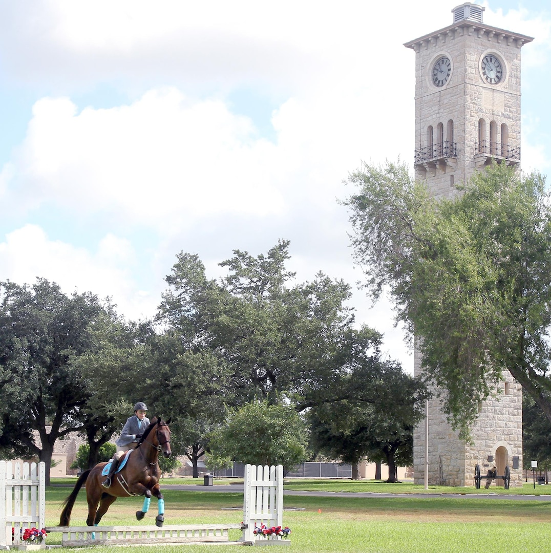 Fort Sam Houston Equestrian Center therapeutic riding instructor Annie Blakely demonstrates the horsemanship event of the modern pentathlon at the Army North Brigade Health Promotion meeting at the Quadrangle Sept. 2. The modern pentathlon was introduced as a way to increase esprit de corps and healthy competition amongst Army units on Fort Sam Houston.