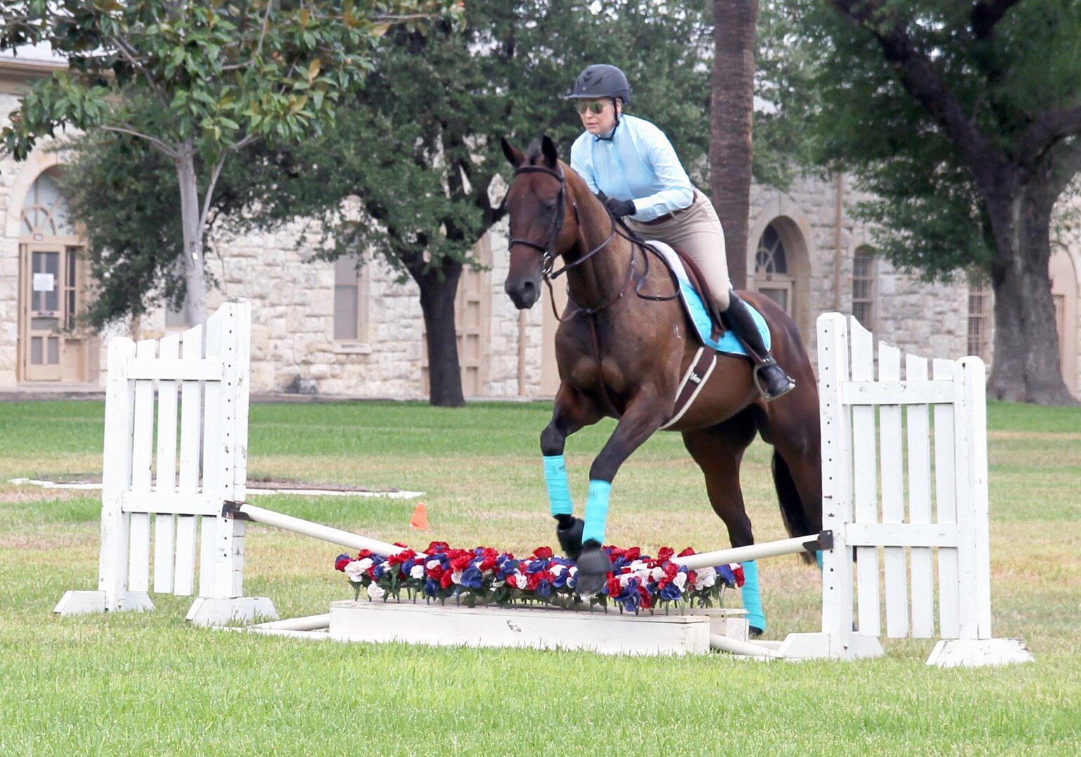 Fort Sam Houston Equestrian Center therapeutic riding instructor Annie Blakely and “Widowmaker” demonstrate the equestrian portion of the modern pentathlon at the Army North Brigade Health Promotion meeting at the Quadrangle Sept. 2. In the equestrian event, competitors will not be allowed to ride their own horses. Instead, they must “draw” a horse shortly before competing to demonstrate their horsemanship on an unfamiliar steed.