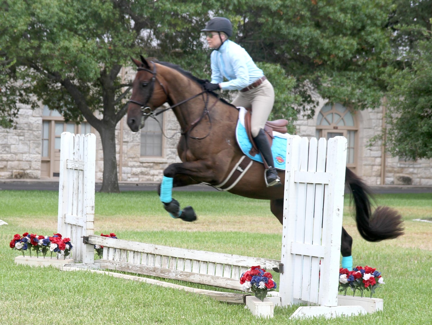 Fort Sam Houston Equestrian Center therapeutic riding instructor Annie Blakely demonstrates the horsemanship event of the modern pentathlon at the Army North Brigade Health Promotion meeting at the Quadrangle Sept. 2. The modern pentathlon was introduced as a way to increase esprit de corps and healthy competition amongst Army units on Fort Sam Houston.