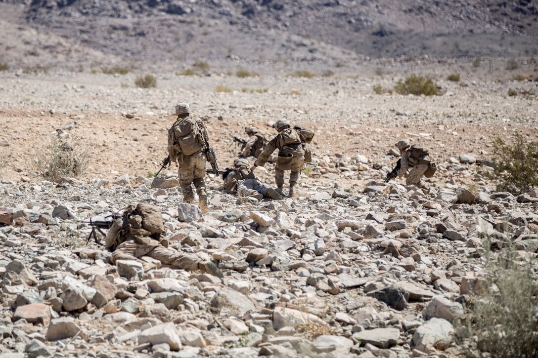 Marines with Company “G”, 2nd Battalion, 1st Marine Regiment, maneuvers to an new firing position to provide suppression during a platoon attack mission during Realistic Urban Training Exercise (RUTEX) at range 410 Alpha aboard Marine Corps Air Ground Combat Center Twentynine Palms, Calif., Sept. 1, 2015. RUTEX provides Marines and Sailors of the 13th Marine Expeditionary Unit (13th MEU) an opportunity to perform and practice their duties while deployed in an urban environment. (U.S. Marine Corps photo by Sgt Hector de Jesus/Released)