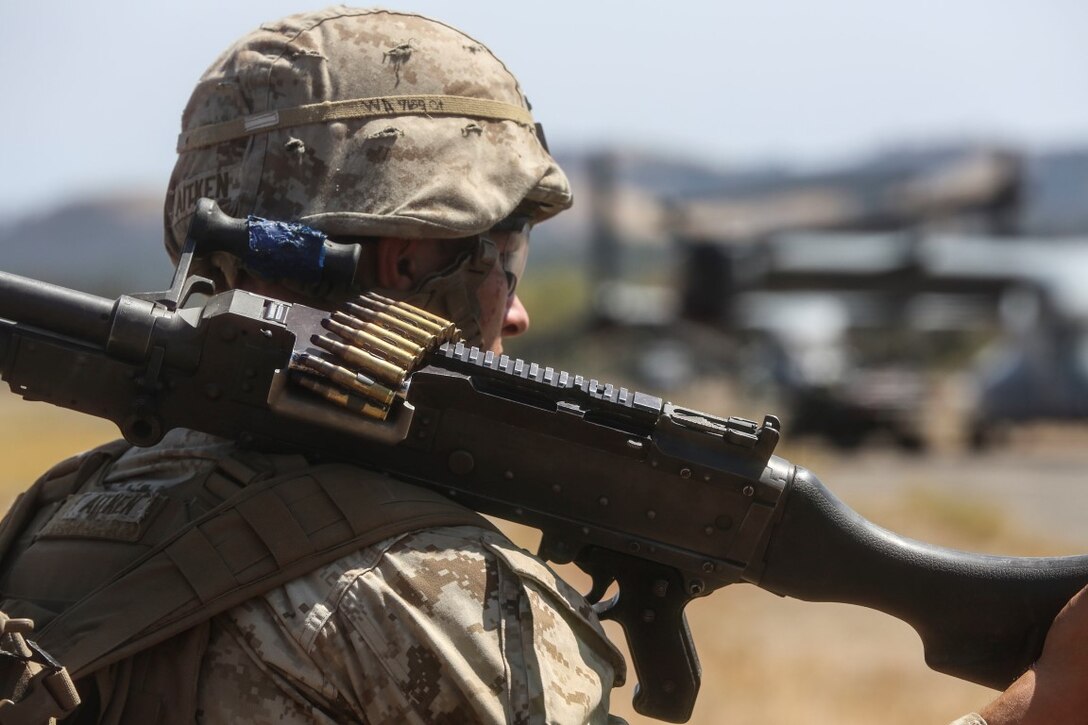 A U.S. Marine with Battalion Landing Team (BLT) 2/1, the ground combat element attached to the 13th Marine Expeditionary Unit, shoulders an M240G medium machine gun during a Tactical Recovery of Aircraft and Personnel (TRAP) mission at Realistic Urban Training (RUT) Exercise aboard Fort Hunter Liggett, California, Sept. 1, 2015. RUT is the final ground-based training requirement prior to deployment, as the 13th MEU moves toward operating embarked at sea. (U.S. Marine Corps photo by Sgt. Paris Capers/ Released)
