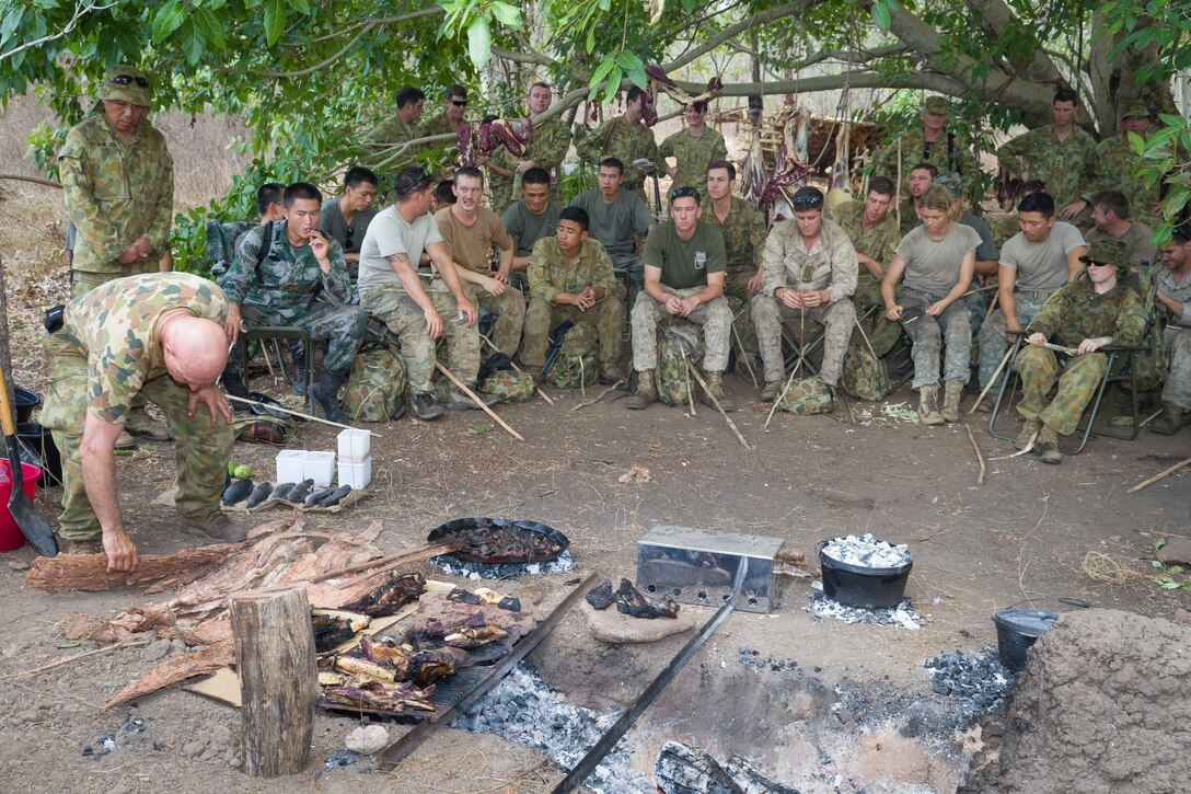 Australian Army soldiers join U.S. Marines with 1st Batalion, 4th Marine Regiment, Marine Rotational Force - Darwin, U.S. Army soldiers with the 25th Infantry Division, U.S. Army Pacific, and Chinese People's Liberation Army soldiers for a demonstration of cooking methods during Exercise Kowari, being conducted in the Daly River region of the Northern Territory. Kowari is a trilateral environmental survival training opportunity hosted by Australia and includes forces from Australia, China and the U.S. simultaneously. (Courtesy Photo by Australian Defence Force LCPL Kyle Genner/Released)
