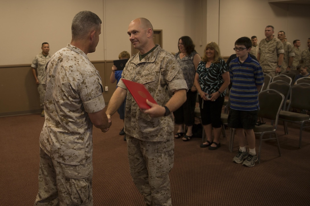 Col. Jay D. Wylie, assistant chief of staff, G-4 Installations and Logistics, Headquarters Battalion, MAGTFTC, shakes hands with Combat Center Commanding General, Maj. Gen. Lewis A. Craparotta, during his promotion at the Officer’s Club, Sept. 1, 2015. (Official Marine Corps photo by Lance Cpl. Connor Hancock)