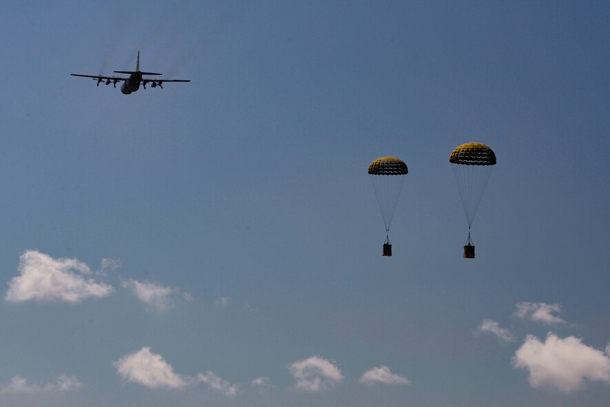 A C-130 Hercules assigned to the North Carolina Air National Guard drops bundles of rice over Baucau Airport, Sept. 8, 2015, near Baucau, Timor-Leste. The rice was donated to a local orphanage as part of Operation Pacific Angel 15-2. Efforts undertaken during Pacific Angel help multilateral militaries in the Pacific improve and build relationships across a wide spectrum of civic operations, which bolsters each nation’s capacity to respond and support future humanitarian assistance and disaster relief operations. (U.S. Air Force photo by Staff Sgt. Alexander W. Riedel/Released)