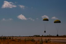 Airdropped bundles of rice land on the Baucau Airport flightline Sept. 8, 2015, near Baucau, Timor-Leste. The rice was deliverd per airdropped by a North Carolina Air National Guard C-130 Hercules and donated to a local orphanage as part of Operation Pacific Angel 15-2. Efforts undertaken during Pacific Angel help multilateral militaries in the Pacific improve and build relationships across a wide spectrum of civic operations, which bolsters each nation’s capacity to respond and support future humanitarian assistance and disaster relief operations. (U.S. Air Force photo/Staff Sgt. Alexander W. Riedel/Released)
