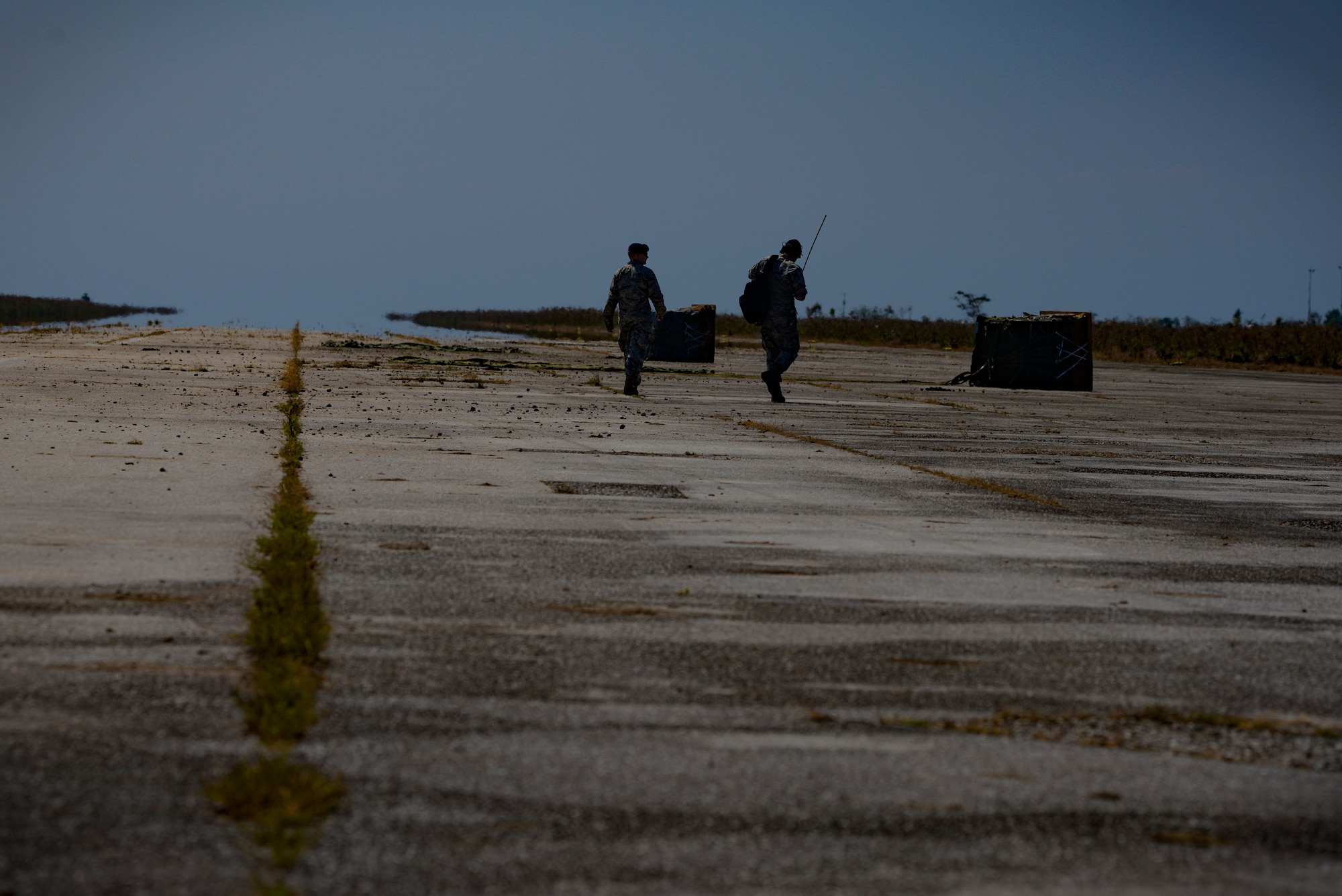 U.S. Air Force Captains Jay Bateman, 736th Security Forces Squadron director of operations, and Christopher Baird,  621st Mobility Support Operations Squadron air mobility liaison, examine two airdropped packages on an airfield Sept. 8, 2015, in Baucau, Timor-Leste. The packages of rice were airdropped by a North Carolina Air National Guard C-130 Hercules during Operation Pacific Angel 15-2. Efforts undertaken during Pacific Angel help multilateral militaries in the Pacific improve and build relationships across a wide spectrum of civic operations, which bolsters each nation’s capacity to respond and support future humanitarian assistance and disaster relief operations. (U.S. Air Force photo by Staff Sgt. Alexander W. Riedel/Released)