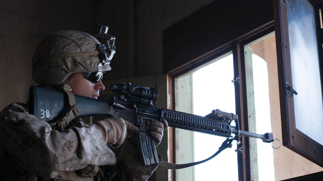 A Marine with 1st Battalion, 5th Marine Regiment scans out of a window for a simulated enemy in the Infantry Immersion Trainer during Exercise Dawn Blitz at Marine Corps Base Camp Pendleton, California, Sept. 7, 2015.  Dawn Blitz is a multinational training exercise being conducted by Expeditionary Strike Group Three and 1st Marine Expeditionary Brigade to build U.S., Japan, Mexico and New Zealand’s amphibious operations and command and control capabilities through live, simulated and constructive military training activities.