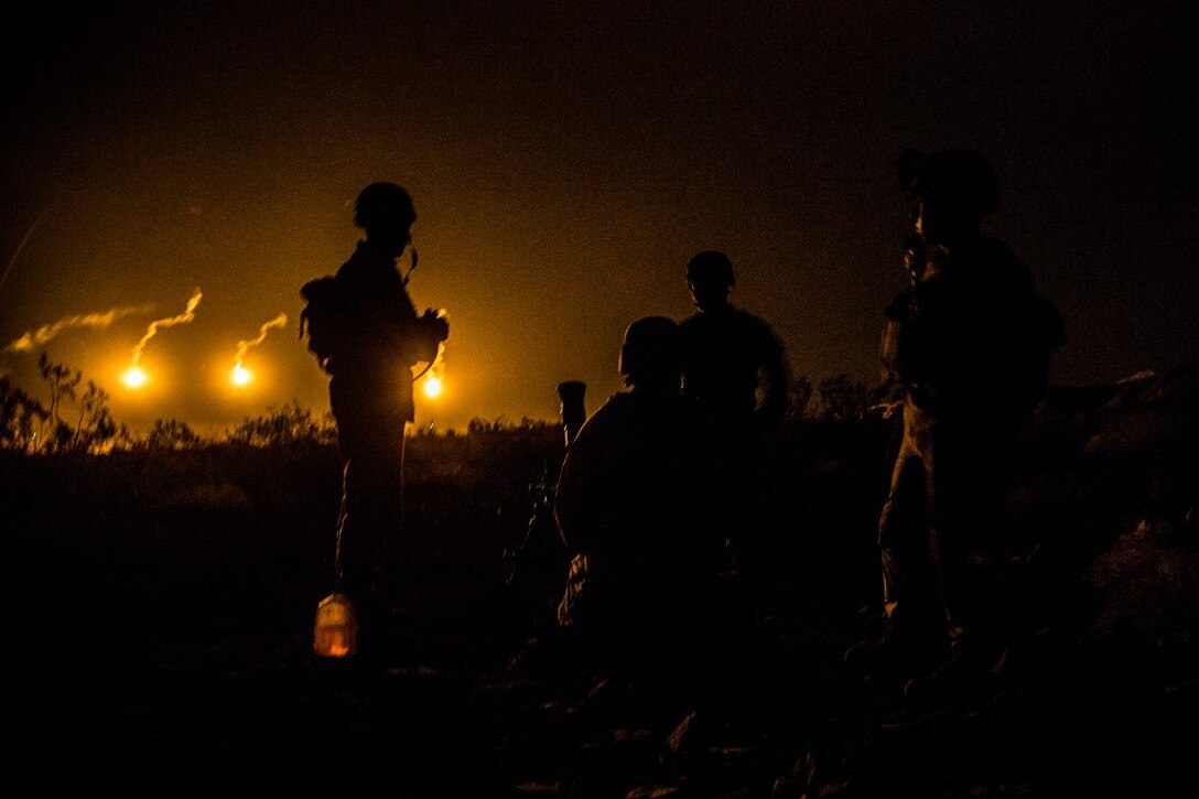 Marines with 81mm Mortar Platoon, Weapons Company, 2nd Battalion, 1st Marine Regiment, watch lamination flairs before receiving a fire mission during Realistic Urban Training Exercise (RUTEX) at range 210 aboard Marine Corps Air Ground Combat Center Twenty-nine Palms, Calif., Sept. 2, 2015. RUTEX provides Marines and Sailors of the 13th Marine Expeditionary Unit (13th MEU) an opportunity to perform and practice their duties while deployed in an urban environment.(U.S. Marine Corps photo by Sgt Hector de Jesus/Released)
