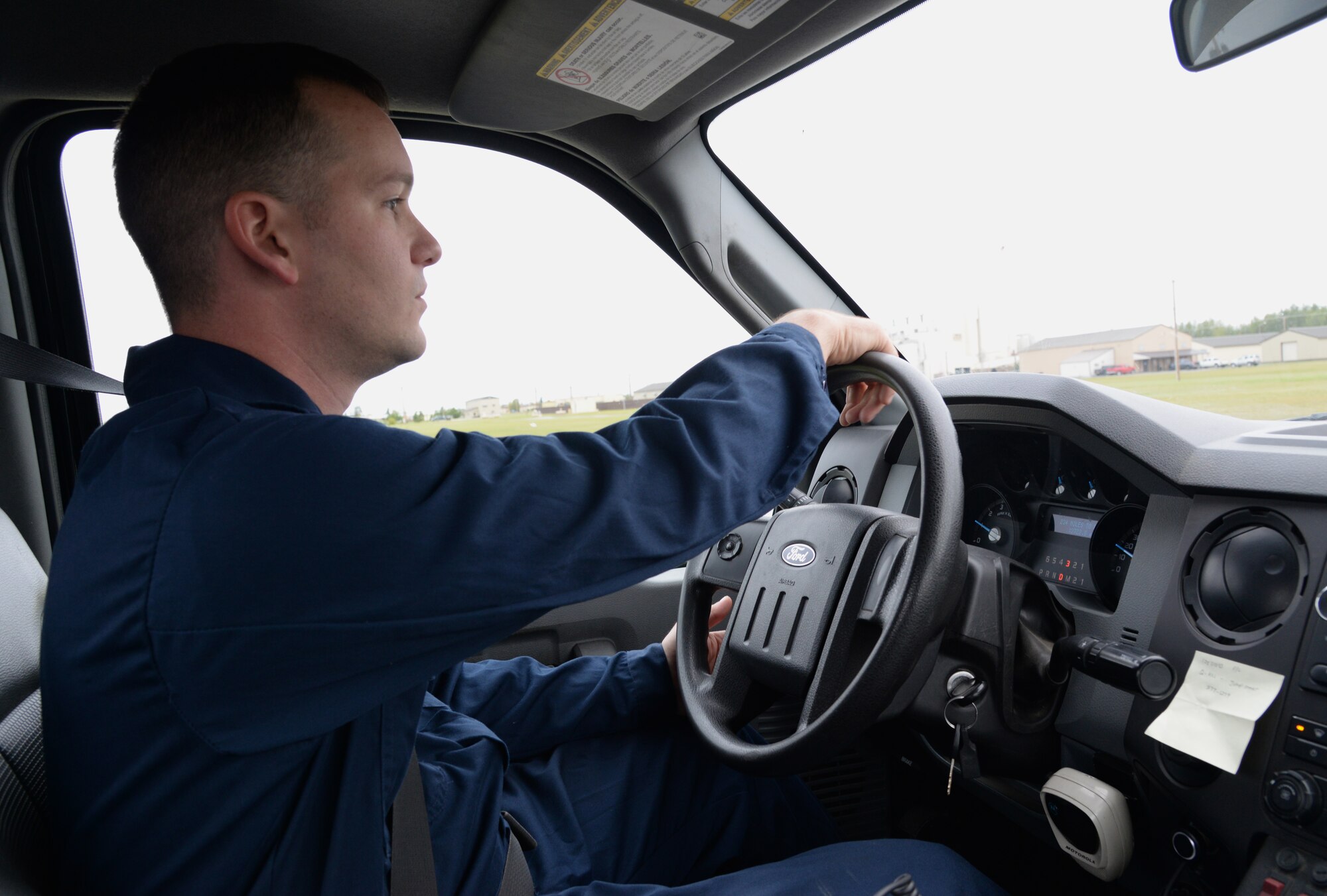 U.S. Air Force Senior Airman Blake Crowe, a 354th Logistics Readiness Squadron vehicle maintenance journeyman, drives to the site of a mobile call, Aug. 31, 2015, at Eielson Air Force Base, Alaska. Crowe receives calls to fix vehicles that can’t be taken into the shop due to expended batteries or unknown mechanical problems. (U.S. Air Force photo by Airman 1st Class Cassandra Whitman/Released)