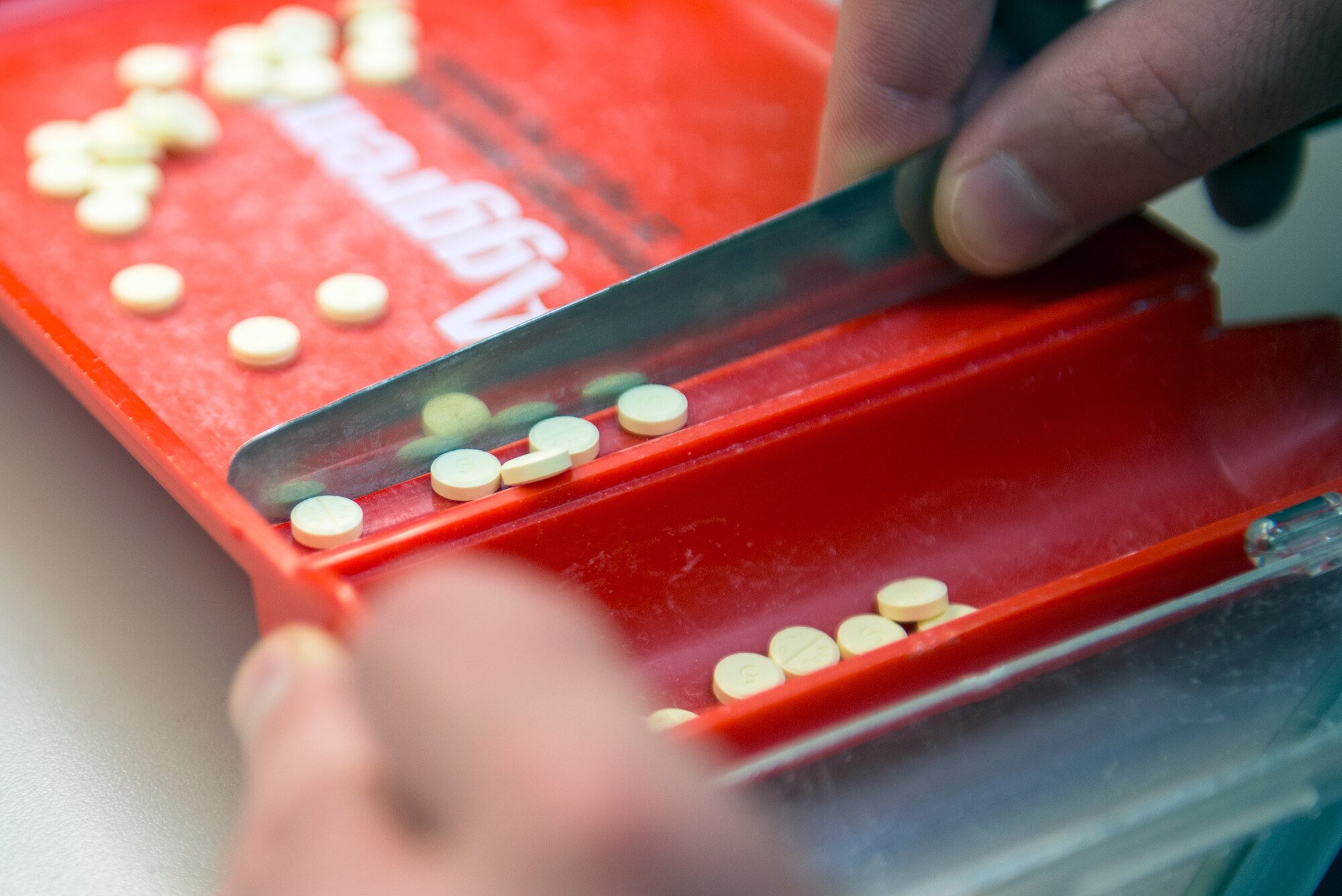 An Airman from the 23d Medical Group pharmacy flight counts tablets before filling a prescription Sept. 8, 2015, at Moody Air Force Base, Ga. The pharmacy serves beneficiaries from Georgia and Florida. (U.S. Air Force photo by Airman 1st Class Greg Nash/Released) 