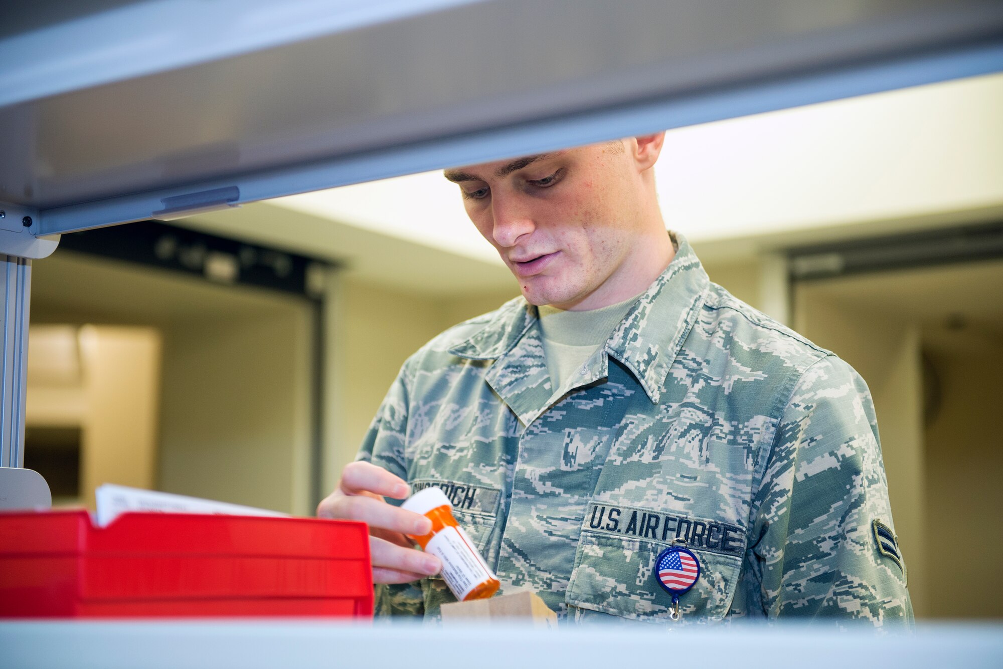 U.S. Air Force Airman 1st Class Chris Gingerich, 23d Medical Group pharmacy technician, reviews a prescription medication bottle before serving a customer Sept. 8, 2015, at Moody Air Force Base, Ga. On average, the pharmacy fills 12,000 prescriptions per month. (U.S. Air Force photo by Airman 1st Class Greg Nash/Released)  