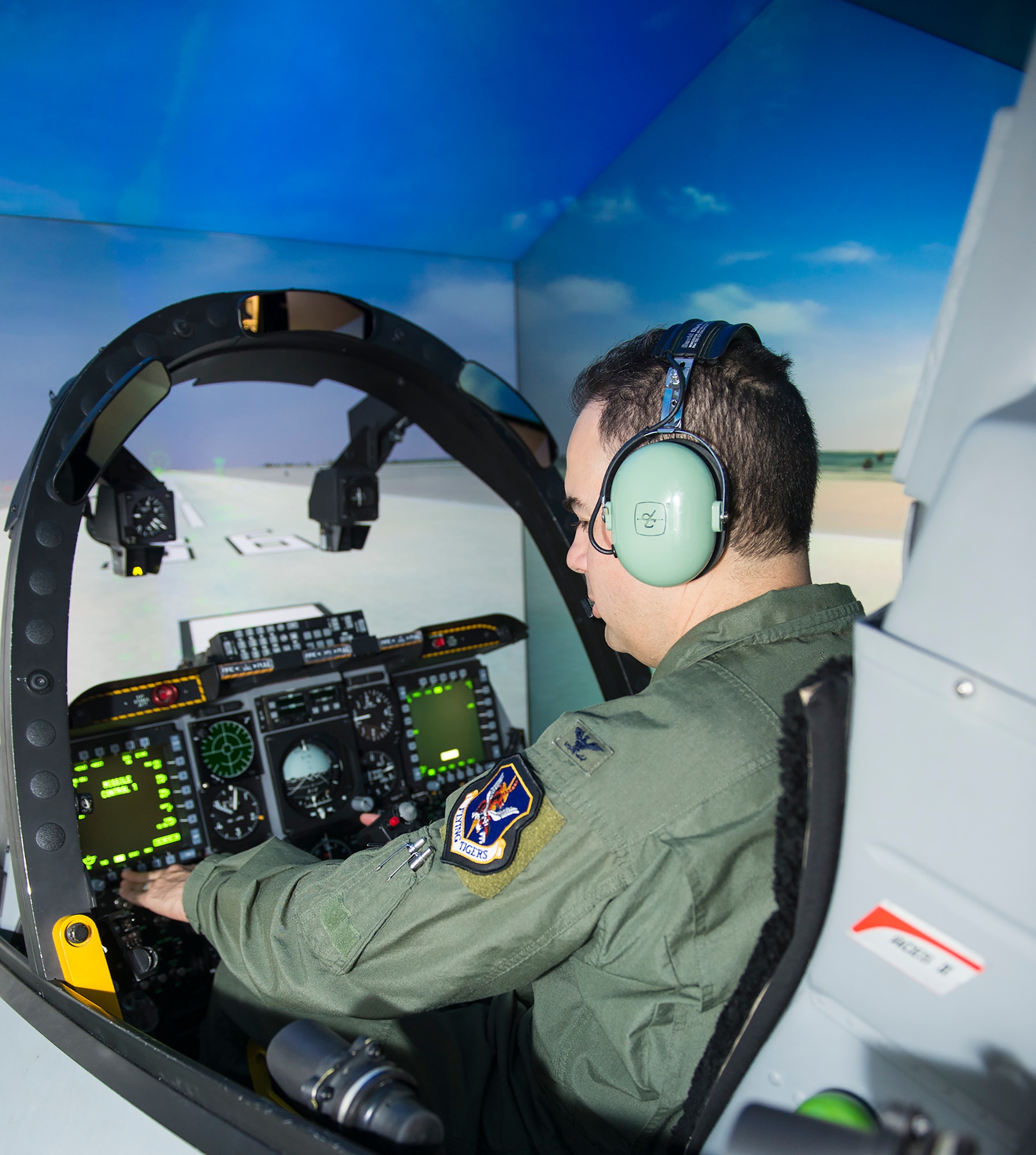 U.S. Air Force Col. Mark Barrera, 23d Wing vice commander, utilizes switches during training in an A-10C Thunderbolt II Full Mission Trainer Sept. 3, 2015, at Moody Air Force Base, Ga. The FMT simulator is cost effective and saves pennies on the dollar compared to the thousands of dollars used during actual flight in the A-10 aircraft. (U.S. Air Force photo by Airman 1st Class Greg Nash/Released) 