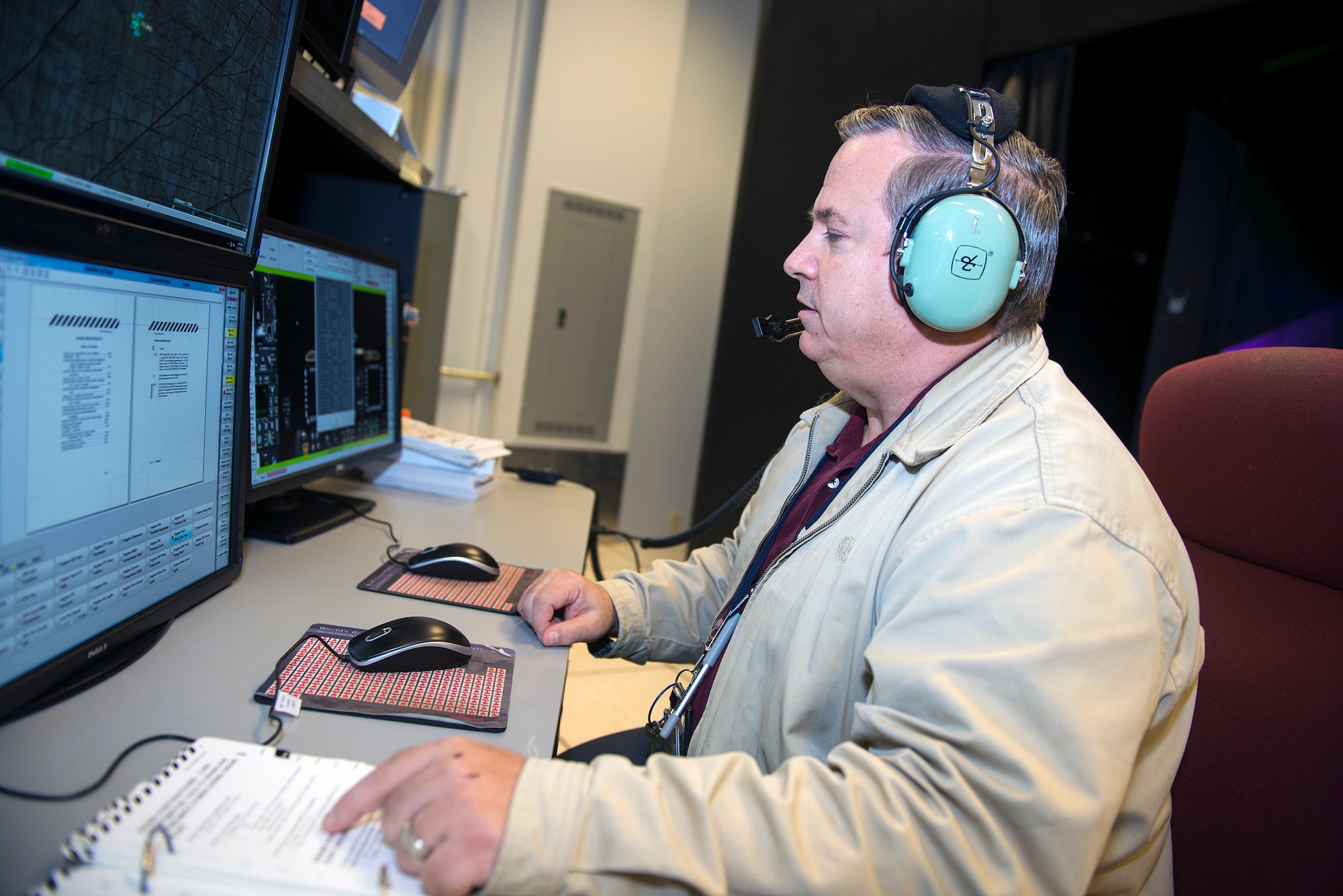 Steven Callich, A-10C Thunderbolt II Full Mission Trainer instructor, communicates with a pilot during a FMT simulator training Sept. 3, 2015, at Moody Air Force Base, Ga. FMT instructors are responsible for training approximately 60 pilots in the 23d Fighter Group on flying proficiency using the simulator before a pilot’s actual flight. (U.S. Air Force photo by Airman 1st Class Greg Nash/Released) 