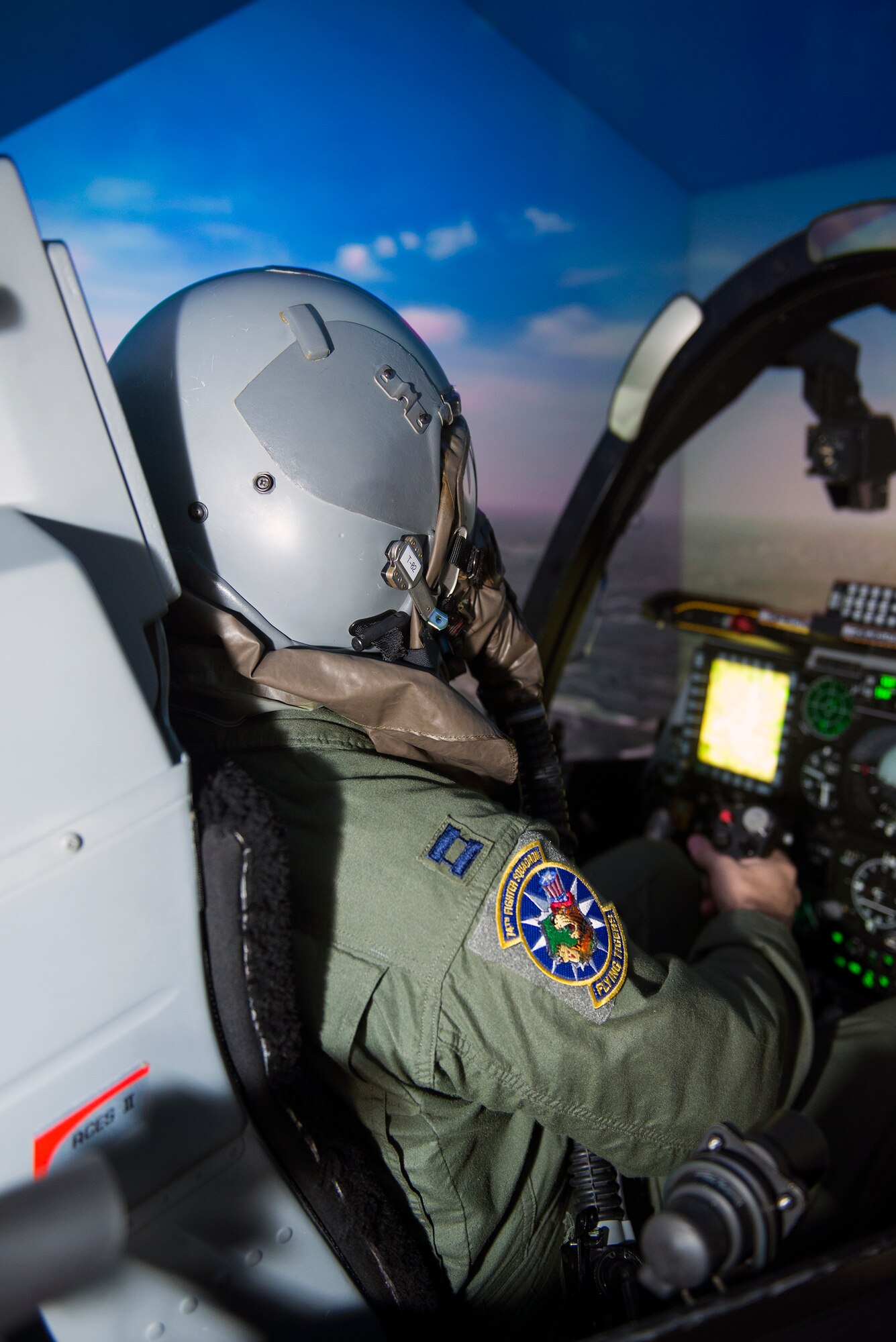 U.S. Air Force Capt. Thomas Ainscough, 74th Fighter Squadron pilot, performs tactical training in an A-10C Thunderbolt II Full Mission Trainer Sept. 2, 2015, at Moody Air Force Base, Ga. The simulator is designed to train the 74th and 75th Fighter Squadron’s A-10 pilots on flight proficiency through tactical and simulated emergency procedure training. (U.S. Air Force photo by Airman Greg Nash/Released)