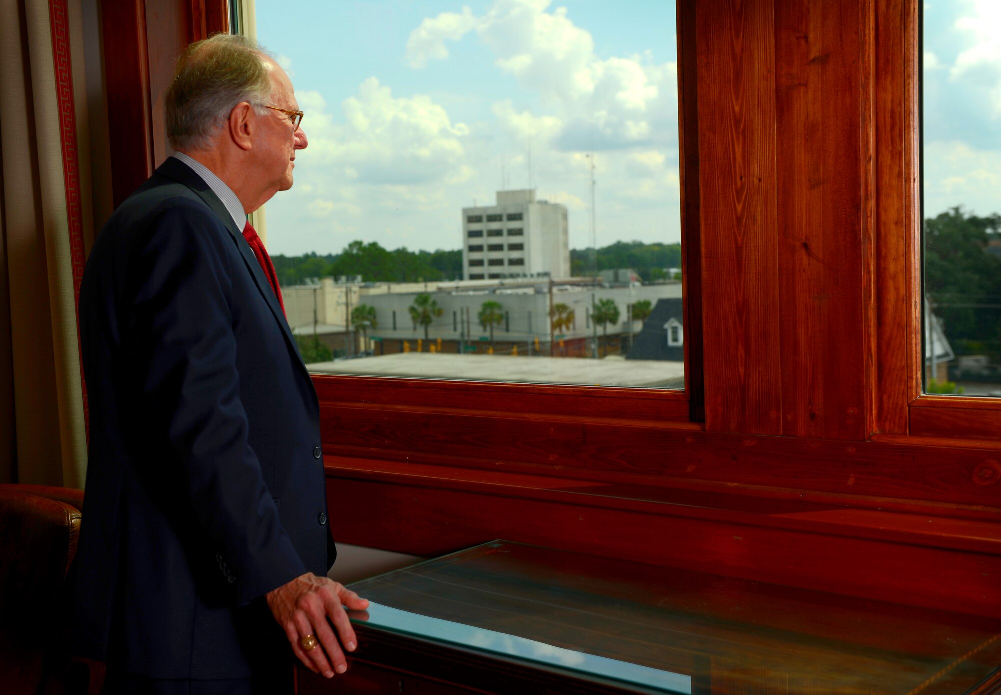 Former U.S. Air Force Capt. Joseph McElveen peers out a window from the Sumter Opera House in Sumter, S.C., Aug. 25, 2015. McElveen has spent the past 15 years as city mayor working to improve the city and build relations between Shaw Air Force Base, S.C., and Sumter. (U.S. Air Force photo by Senior Airman Jensen Stidham/Released)