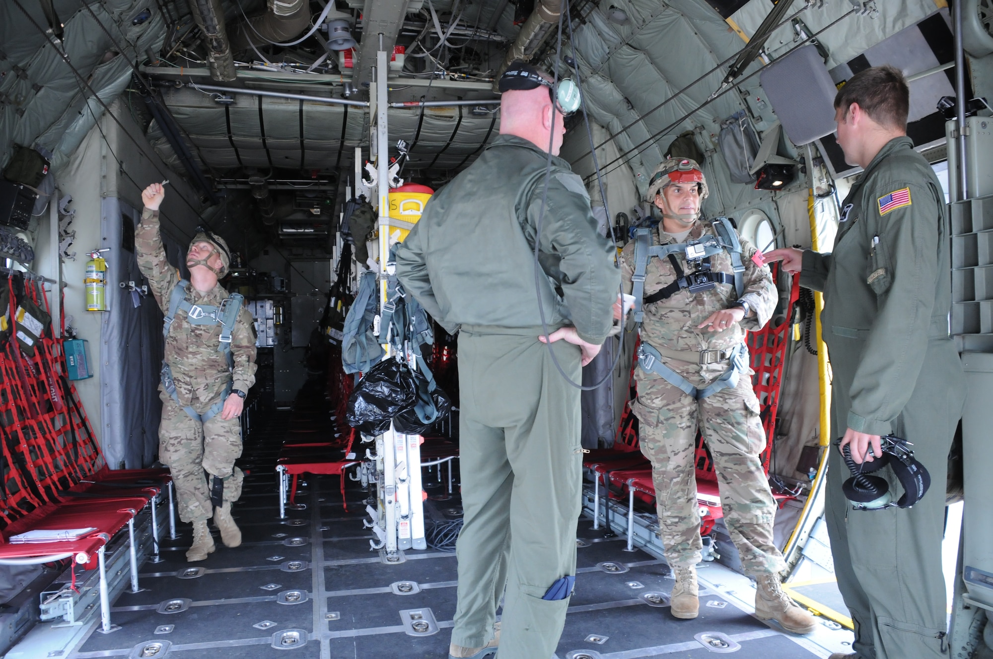 Staff Sgt. Pat Englishby and Senior Airman Ken Zidell, loadmasters, 328th Airlift Squadron, discuss procedures with jumpmasters from the 173 Airborne Brigade at Aviano Air Base, Italy, on Aug. 24, 2015. Englishby and Zidell were preparing for Exercise Swift Response, a joint training exercise. (U.S. Air Force photo by Staff Sgt. Matthew Burke/released)