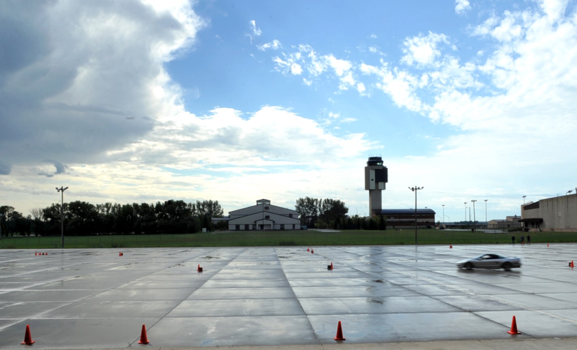 A racer navigates the race track set up in the free zone by the 3-Bay Hangar during the 2015 Autocross event on Grand Forks Air Force Base, North Dakota, Sept. 6, 2015. About 60 individuals participated in the event which raised more than $1,800 in proceeds for Project Lifesaver, a non-profit organization that specializes in the search and rescue of individuals with cognitive disorders. (U.S. Air Force photo by Airman 1st Class Bonnie Grantham/released)