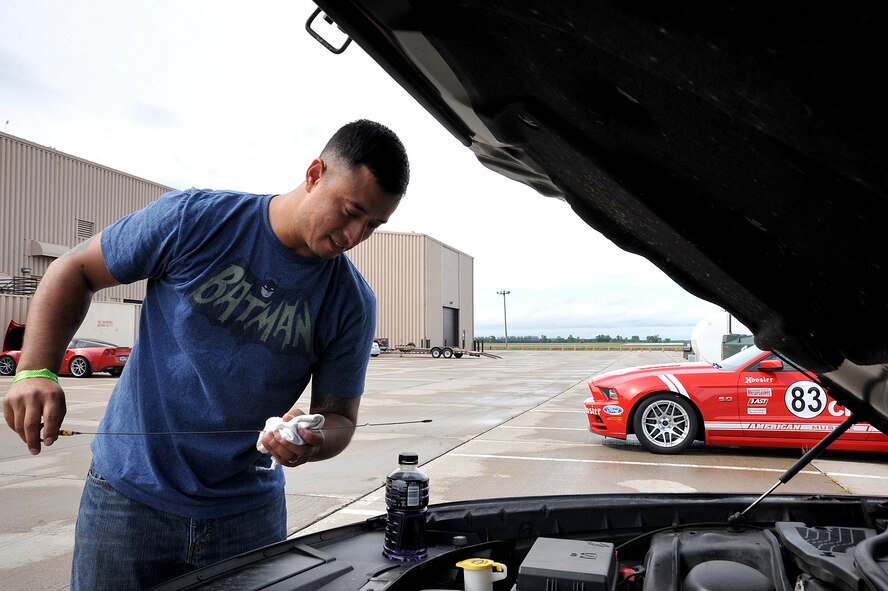 Tech. Sgt. Luis Ochoa, 319th Logistics Readiness Squadron NCO-in-charge of special purpose maintenance, checks the oil of his car’s engine before heading out for the race at the 2015 Autocross on Grand Forks Air Force Base, North Dakota, Sept. 6, 2015. The race consisted of three heats, and each car was able to take on the course three times within their heat. (U.S. Air Force photo by Airman 1st Class Bonnie Grantham/released)