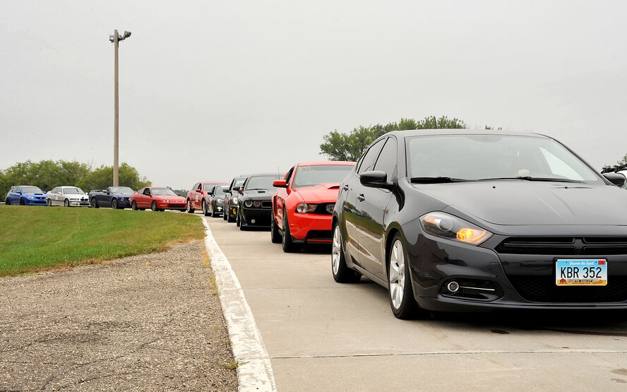 Participants in the 2015 Autocross event line up behind the starting line on Grand Forks Air Force Base, North Dakota, Sept. 5, 2015. More than 60 individuals participated in the event, including military and civilians from the local area. (U.S. Air Force photo by Airman 1st Class Bonnie Grantham/released)