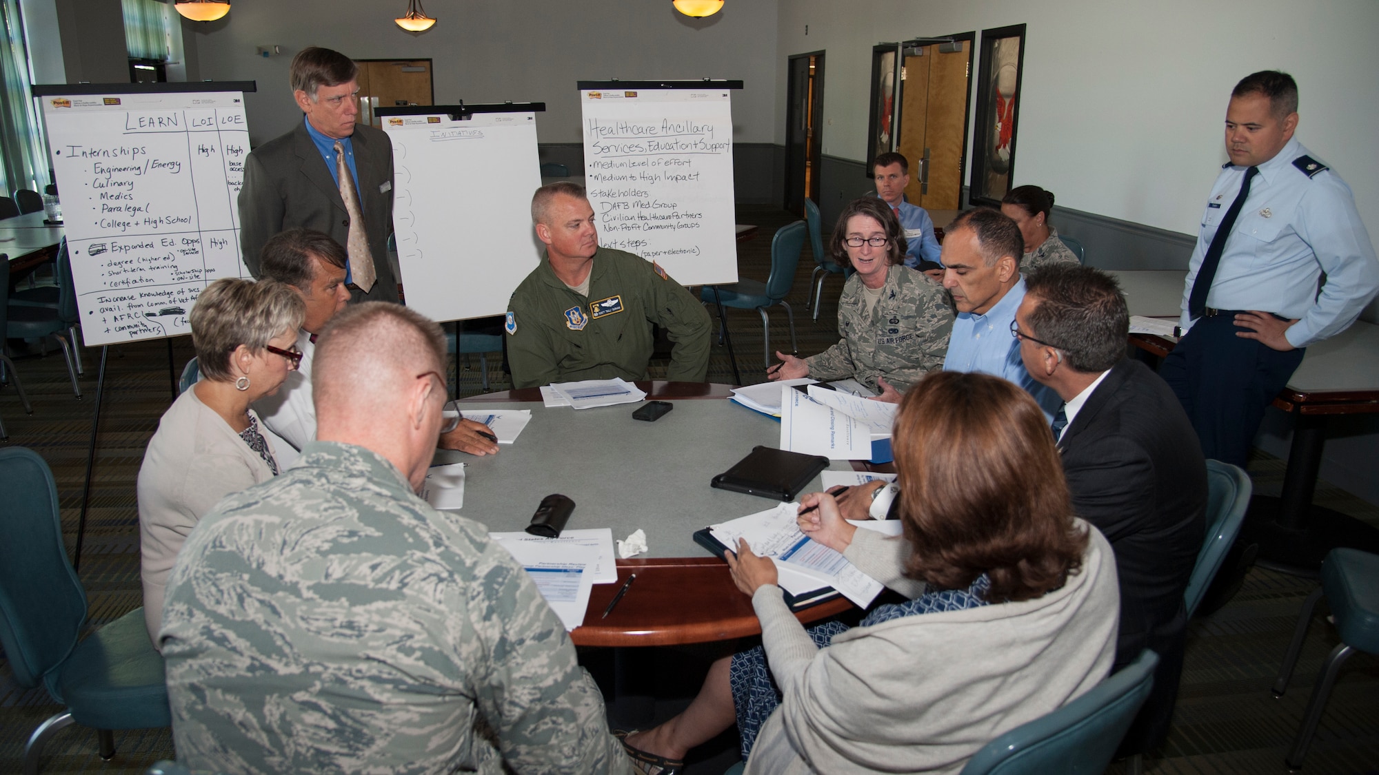 Team Dover leadership talks with prominent members of the Dover community during the Public-Public/Public/-Private Partnership mid-planning meeting on August 26, 2015, at The Landings on Dover Air Force Base, Del. The Air Force program, otherwise known as P4 is intended to increase partnership opportunities between Air Force installations and community businesses and organizations. (U.S. Air Force photo/Senior Airman Jared Duhon)