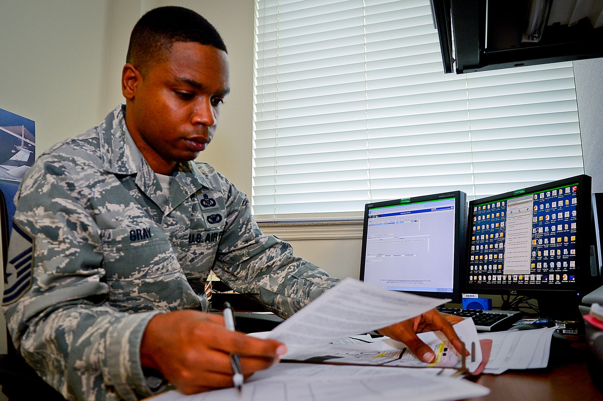 Master Sgt. Patrick Gray, 91st Air Refueling Squadron NCO in charge of aviation resource management, reviews mission paper work prior to inputting data into the ARM system database at MacDill Air Force Base, Fla., Sept. 3, 2015. Gray maintains daily flight mission data to indicate the takeoff, in-flight and landing status of each flight. (U.S. Air Force photo by Senior Airman Ned T. Johnston/Released)