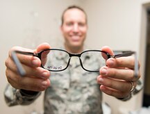 Maj. Peter Carra, 628th Medical Group Optometry flight commander places glasses on a patient Sep. 9, 2015, at Joint Base Charleston – Air Base, S.C. The optometry office provides services such as eye examinations, visual acuity checks, repairing glasses, color vision tests and comprehensive exams. To set up an appointment, call the Air Base optometry clinic at 843-963-6880. (U.S. Air Force photo/Airman 1st Class Clayton Cupit)