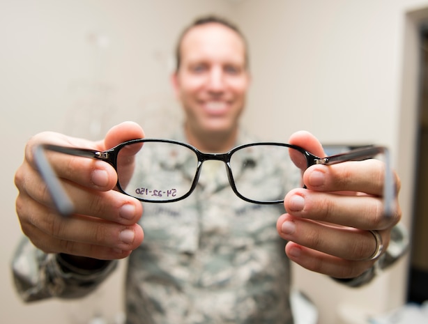 Maj. Peter Carra, 628th Medical Group Optometry flight commander places glasses on a patient Sep. 9, 2015, at Joint Base Charleston – Air Base, S.C. The optometry office provides services such as eye examinations, visual acuity checks, repairing glasses, color vision tests and comprehensive exams. To set up an appointment, call the Air Base optometry clinic at 843-963-6880. (U.S. Air Force photo/Airman 1st Class Clayton Cupit)