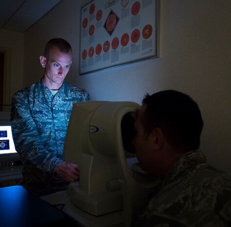 Tech. Sgt. Wesley Catoe, 628th MDG optometry NCOIC studies information from his optometry equipment Sep. 9, 2015, at the optometry clinic on Joint Base Charleston, S.C. The optometry office provides services such as eye examinations, visual acuity checks, repairing glasses, color vision tests and comprehensive exams. To set up an appointment, call the Air Base optometry clinic at 963-6880. (U.S. Air Force photo/Airman 1st Class Clayton Cupit)
