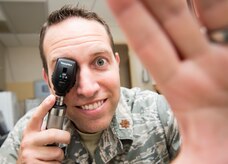 Maj. Peter Carra, 628th Medical Group Optometry flight commander, demonstrates looking into a patient’s eye Sep. 9, 2015, at Joint Base Charleston – Air Base, S.C. The optometry clinic provides services such as eye examinations, visual acuity checks, repairing glasses, color vision tests and comprehensive exams. To set up an appointment, call the Air Base optometry clinic at 843-963-6880. (U.S. Air Force photo/Airman 1st Class Clayton Cupit)